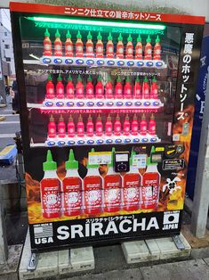 a vending machine that sells sriracha sauces on the side of the street