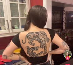 a woman with a tiger tattoo on her back