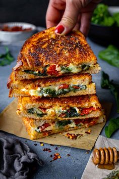 a stack of grilled cheese sandwiches on a cutting board