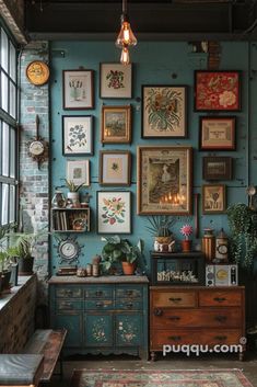 a room filled with lots of framed pictures on the wall next to a dresser and window