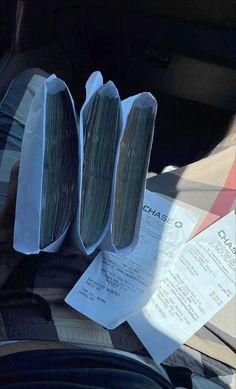 three pieces of paper sitting on the back seat of a car