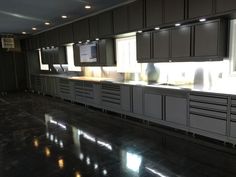 an empty kitchen with lots of cabinets and counter tops in the middle of the room