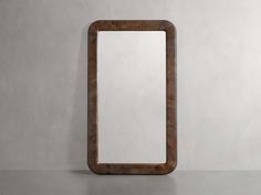 a wooden mirror sitting on top of a table