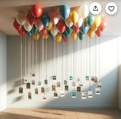 a bunch of balloons are hanging from the ceiling in an empty room with pictures on them