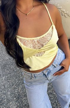 Satin Yellow Lace Crop Top

How to style:
Stunning new summer top ALERT!!! This top is the perfect breathable crop top () to rock during summer () with lace detailing and cut outs to elevate any outfit. Pair this top with a long white maxi skirt () and sneakers for every day wear or add some heels to be fit to grab cocktails with the gals. Finalising this fit with gold jewellery () will tie this outfit all together

Features: 
  
 * Light weight satin material 
 * Slight stretch 
 * Lined 
 * Lace centre bust detailing 
 * Thin elastic back band 
 *  Thin adjustable straps
  
 * Left invisible zip 
 * Slightly cropped length 
 * Scoop neckline Maxi Skirt And Sneakers, Long White Maxi Skirt, Cropped Aesthetic, White Maxi Skirt, White Maxi Skirts, Satin Crop Top, Summer Playsuit, Yellow Satin, Summer Yellow