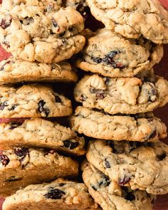 a pile of oatmeal cookies sitting on top of a red table cloth