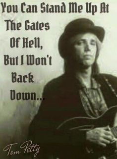 a man with a hat is holding a guitar and the words you can stand me up at the gates of hell, but i won't back down