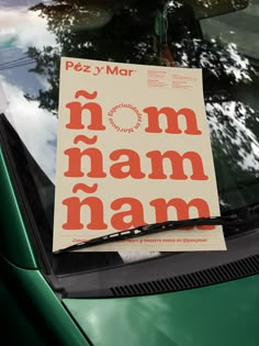 a piece of paper that says mom nam namn on the hood of a green car