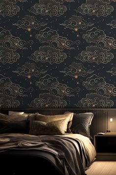 a bed sitting under a night sky wallpaper next to a nightstand with a lamp on it