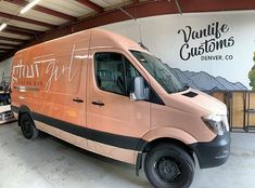 an orange van is parked in a garage