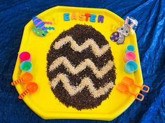 a child's birthday cake made to look like an easter egg on a yellow plate