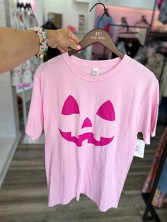 Introducing the Pink-O-Lantern Light Pink tee – the spookiest way to show off your style! Featuring a light pink fabric and a magenta pumpkin face, you can make it through Halloween in style. Trick-or-treating? No more frights – you’ll look oh-so-bright! Spooky Pink T-shirt For Halloween, Pink Cotton T-shirt For Halloween, Light Pink Fabric, Pumpkin Face, Trick Or Treating, Floral Outfit, Pumpkin Faces, Pink Tee, Midi Maxi Dress