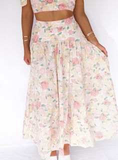 Introducing our Lush Garden Midi Skirt - the ultimate two-in-one outfit for any occasion. With its charming floral skirt and coordinating tie tank, you'll be ready for a bridal shower or fancy tea party in no time. Perfect for those who enjoy the sweeter things in life! Fabric 100% Rayon Floral Print Tiered Skirt For Garden Party, Floral Print Flowy Maxi Skirt For Brunch, Floral Print Midi Skirt For Brunch, Brunch Floral Print Flowy Maxi Skirt, Elegant Floral Print Bottoms For Brunch, Long Floral Print Skirt For Brunch, Tiered Skirt With Floral Print For Garden Party, Feminine Floral Print Tiered Skirt, Tiered Floral Print Skirt For Garden Party