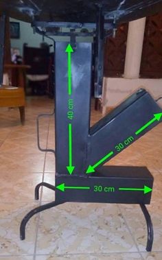 the back end of a black table with green arrows pointing up to it's top