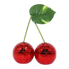 two shiny red disco balls and a green leaf