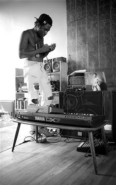 a man standing on top of a table next to a radio