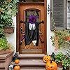 a front door decorated for halloween with pumpkins