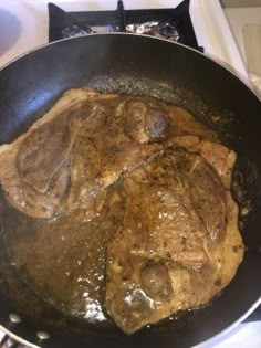 steak is cooking in a skillet on the stove