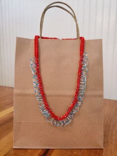 a brown paper bag with red, white and blue beads on it