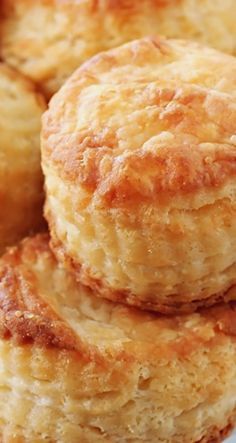 some biscuits are in a white bowl on a blue and white table cloth