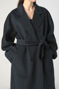 Stay Warm and Fashionable in Our Women's Woolen Coat with Belt This elegant single breast coat features weld pockets, and a tie belt. Stitching along the seams adds details to the piece. This extra long style is spun with wool and cashmere, making it warm, wind resistant, and sophisticated. Style #: WWAH914