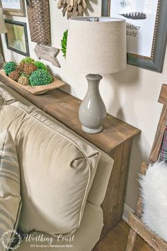 a living room filled with furniture and pictures on the wall