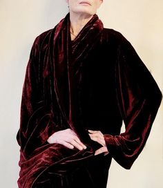 This dramatic vintage evening coat and dress is made of thick, luxurious silk velvet in a deep, rich burgundy. The open front coat sweeps down to the floor, and features a wide shawl-collar and bell sleeves. The sleeveless dress with scoop neck, has a slightly a-line shape, and is finished with mother-of-pearl side buttons. Vintage, ca. 1990s 100% silk Made in U.S.A  Machine washable Tagged size Large Measurements (taken flat) Dress: Bust pit to pit: 20in./50.8cm. Waist: 20.5in./52.07cm. Hip: 23.5in./59.69cm. Length: 51in./129.54cm. Coat: Pit to pit: 24in./60.96cm. Length: 56in./142.24cm. Citron Santa Monica is an exclusive women's boutique, specializing in unique apparel, made of embossed silk, velvet, and satin. Fabrics are transformed into stunning wearable works of art using artisan te Elegant Velvet Outerwear For Costume, Elegant Formal Robe For Fall, Fitted Formal Robe For Fall, Elegant Shawl Collar Robe For Fall, Coat And Dress, Evening Coat, Rich Burgundy, Vintage Velvet, Silk Velvet