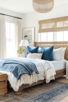 a bed with blue and white pillows in a bedroom