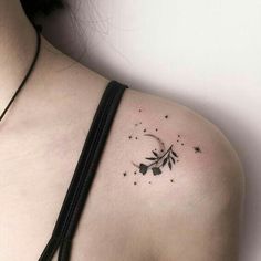 a woman's shoulder with stars and a crescent tattoo on her left side ribcage