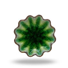 a green and white plate sitting on top of a table