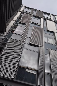 a tall building with lots of windows and shutters