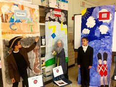 three children are standing in front of their art work at the school's art show