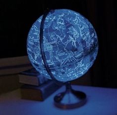 an illuminated globe sitting on top of a table