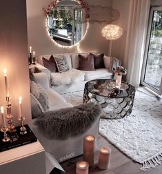 a living room filled with furniture and candles