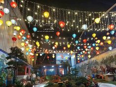 many colorful lanterns are hanging from the ceiling