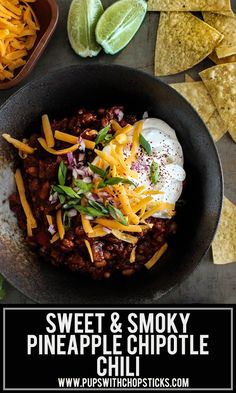 a bowl filled with chili and cheese next to tortilla chips