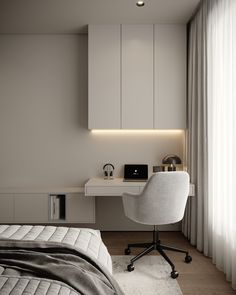 a white bed sitting next to a desk with a laptop on top of it in a bedroom