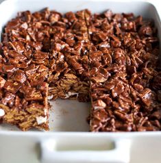 chocolate dessert in a white dish with one slice cut out