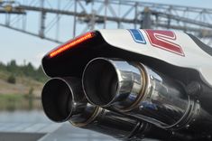 a close up view of a motorcycle exhaust pipe with the lights turned red and blue