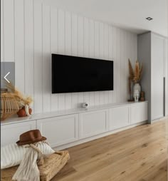 a large flat screen tv mounted to the side of a wall in a living room