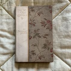 an old garden book is laying on a bed