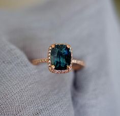 a ring with a blue stone surrounded by diamonds