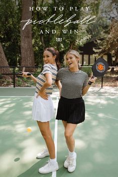 two women standing on a tennis court holding racquets