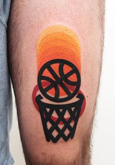 a man with a basketball tattoo on his leg that has an orange and black design