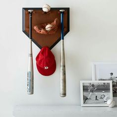 a baseball bat, glove and hat hanging on the wall