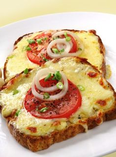 two slices of bread with tomatoes and onions on them