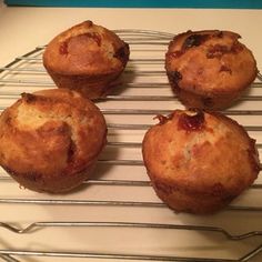 four muffins cooling on a wire rack