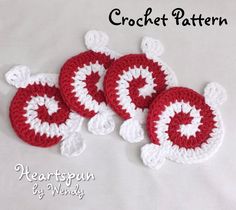 three red and white crocheted coasters with hearts on them