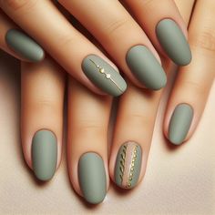 The nails feature a subtle sage green base with a matte finish. Minimalistic gold accents, such as small dots or lines, are strategically placed on each nail. The gold accents are delicate and sparse, adding a touch of sophistication without overpowering the soft sage background. The matte finish gives a chic and understated elegance. Gel X Nails Matte, Classy Short Oval Nails, Mauve Matte Nails Dusty Rose, Nail Colours Green, Autumn Nails Sage Green, Matte With Glitter Nails, Sage Green Nails With Gold Flakes, Olive Green Matte Nails Design, Sage Matte Nails