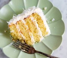 a piece of cake sitting on top of a green plate with a fork next to it